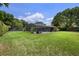 Expansive backyard with a pool and lush greenery, offering privacy and outdoor enjoyment at 8655 Shady Glen Dr, Orlando, FL 32819