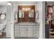 Bathroom with a double sink vanity with granite countertops and wooden backsplash at 8655 Shady Glen Dr, Orlando, FL 32819
