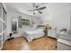 Bright bedroom features cork floors and a comfortable bed, complemented by stylish decor and natural light at 8655 Shady Glen Dr, Orlando, FL 32819