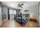 Cozy bedroom with cork floors, a dark wood bed frame and a personalized wall art at 8655 Shady Glen Dr, Orlando, FL 32819