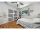 Bedroom featuring unique cork floors, a large window, and a sliding door closet at 8655 Shady Glen Dr, Orlando, FL 32819