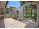An arched gated entry features potted plants and a brick paver courtyard at 8655 Shady Glen Dr, Orlando, FL 32819