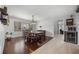 Dining room with wood flooring, a large window, and modern lighting fixtures at 8655 Shady Glen Dr, Orlando, FL 32819