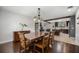 Dining room with a dark wood table and decor connecting to the modern kitchen at 8655 Shady Glen Dr, Orlando, FL 32819
