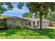Charming single-story home featuring arched accents, lush landscaping, and a two-car garage at 8655 Shady Glen Dr, Orlando, FL 32819