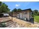 Exterior view of home featuring backyard, boat, and detached home office at 8655 Shady Glen Dr, Orlando, FL 32819
