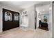 Bright foyer with tiled flooring, a coat rack bench, and a view into the living room at 8655 Shady Glen Dr, Orlando, FL 32819