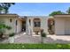 Arched gated entry with potted plants leads to the front door at 8655 Shady Glen Dr, Orlando, FL 32819