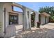 Arched gated entry with potted plants leads to the front door and driveway at 8655 Shady Glen Dr, Orlando, FL 32819