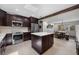 Open kitchen with stainless steel appliances, wood beam, and white countertop island at 8655 Shady Glen Dr, Orlando, FL 32819