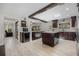 Spacious kitchen featuring dark wood cabinets, a center island, and modern stainless-steel appliances at 8655 Shady Glen Dr, Orlando, FL 32819