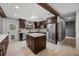 Modern kitchen with stainless steel appliances, an island, and dark wood cabinets with light countertops at 8655 Shady Glen Dr, Orlando, FL 32819