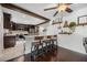 Kitchen with island bar seating featuring wood beam and decor shelves on the wall at 8655 Shady Glen Dr, Orlando, FL 32819