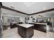 Open concept kitchen with an island, beam ceilings, and view of the dining and living areas at 8655 Shady Glen Dr, Orlando, FL 32819