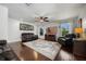Bright living room showcases hardwood floors, comfortable seating, and natural light streaming through large windows at 8655 Shady Glen Dr, Orlando, FL 32819