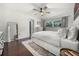 Comfortable main bedroom with hardwood floors, closet access, and a bright window at 8655 Shady Glen Dr, Orlando, FL 32819