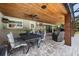 Covered patio area featuring brick flooring, a ceiling fan, and an outdoor dining and seating area at 8655 Shady Glen Dr, Orlando, FL 32819