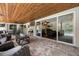 Covered patio with brick flooring, stylish outdoor seating, and a view of the pool and interior at 8655 Shady Glen Dr, Orlando, FL 32819