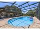 Enclosed in-ground pool with brick patio, screen enclosure, and outdoor seating and entertaining space at 8655 Shady Glen Dr, Orlando, FL 32819