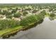 An aerial view showcasing the lake and the community's mature trees and landscaping at 9644 Myrtle Creek Ln, Orlando, FL 32832