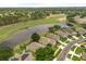 Aerial view of homes alongside pond and golf course at 9644 Myrtle Creek Ln, Orlando, FL 32832