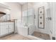Bright bathroom featuring a soaking tub and glass enclosed shower with decorative tile work at 9644 Myrtle Creek Ln, Orlando, FL 32832