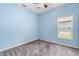 Cozy bedroom with carpet flooring and a window at 9644 Myrtle Creek Ln, Orlando, FL 32832