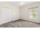 Neutral bedroom with standard closet and window with view to the outdoors at 9644 Myrtle Creek Ln, Orlando, FL 32832