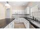 White kitchen featuring stainless steel appliances and granite countertops at 9644 Myrtle Creek Ln, Orlando, FL 32832