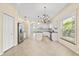Bright kitchen with stainless steel appliances, white cabinets, and an island with a dark countertop at 9644 Myrtle Creek Ln, Orlando, FL 32832