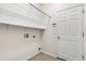 Practical laundry room with white walls, door, and shelving and washer/dryer hookups at 9644 Myrtle Creek Ln, Orlando, FL 32832