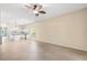 Spacious living room with tile floors, ceiling fan, and open access to the modern kitchen at 9644 Myrtle Creek Ln, Orlando, FL 32832