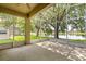 Spacious screened-in patio featuring overhead coverage and a view of the lake at 9644 Myrtle Creek Ln, Orlando, FL 32832