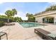 Community pool with chairs, palm trees, and nearby clubhouse at 9644 Myrtle Creek Ln, Orlando, FL 32832