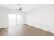 Bright, minimalist bedroom featuring sliding glass doors, wood-look floors, and abundant natural light at 10914 Savannah Wood Dr # 139, Orlando, FL 32832