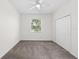 Clean bedroom with large window, carpet, ceiling fan, and closet at 10914 Savannah Wood Dr # 139, Orlando, FL 32832