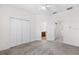 Spacious bedroom with a ceiling fan and large closet featuring an en-suite bathroom and laundry area at 10914 Savannah Wood Dr # 139, Orlando, FL 32832