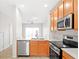 Well-equipped kitchen features stainless steel appliances, granite countertops, and convenient access to the dining area at 10914 Savannah Wood Dr # 139, Orlando, FL 32832