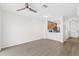 Inviting living room with hard surface floors and a ceiling fan open to a kitchen with stainless appliances at 10914 Savannah Wood Dr # 139, Orlando, FL 32832