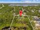 Picturesque aerial shot of property surrounded by lush greenery and a nearby lake at 1189 Rib Ave, St Cloud, FL 34771