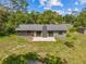 Aerial view of the home with a back patio, surrounded by a spacious lawn at 1189 Rib Ave, St Cloud, FL 34771