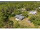A high-angle view of a home on a large lot surrounded by trees and greenery at 1189 Rib Ave, St Cloud, FL 34771