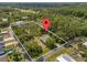 Large 1.73-acre property featuring a house, a pond, and wooded surroundings at 1189 Rib Ave, St Cloud, FL 34771