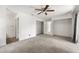 Bedroom featuring carpeting, ceiling fan, walk-in closet, and attached bathroom at 1189 Rib Ave, St Cloud, FL 34771