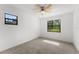 Sunny bedroom with two windows offering green outdoor views and a ceiling fan at 1189 Rib Ave, St Cloud, FL 34771