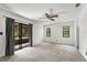 Spacious bedroom features carpeting, sliding glass door, and two windows at 1189 Rib Ave, St Cloud, FL 34771