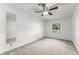 Well-lit bedroom with a ceiling fan, plush carpeting, a window, and a mirror at 1189 Rib Ave, St Cloud, FL 34771