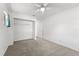 Carpeted bedroom featuring a ceiling fan and an open closet space at 1189 Rib Ave, St Cloud, FL 34771
