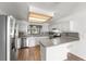 Bright kitchen featuring stainless steel appliances, white cabinets, and a breakfast bar at 1189 Rib Ave, St Cloud, FL 34771