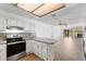Open kitchen area with stainless steel appliances and view into the living room at 1189 Rib Ave, St Cloud, FL 34771
